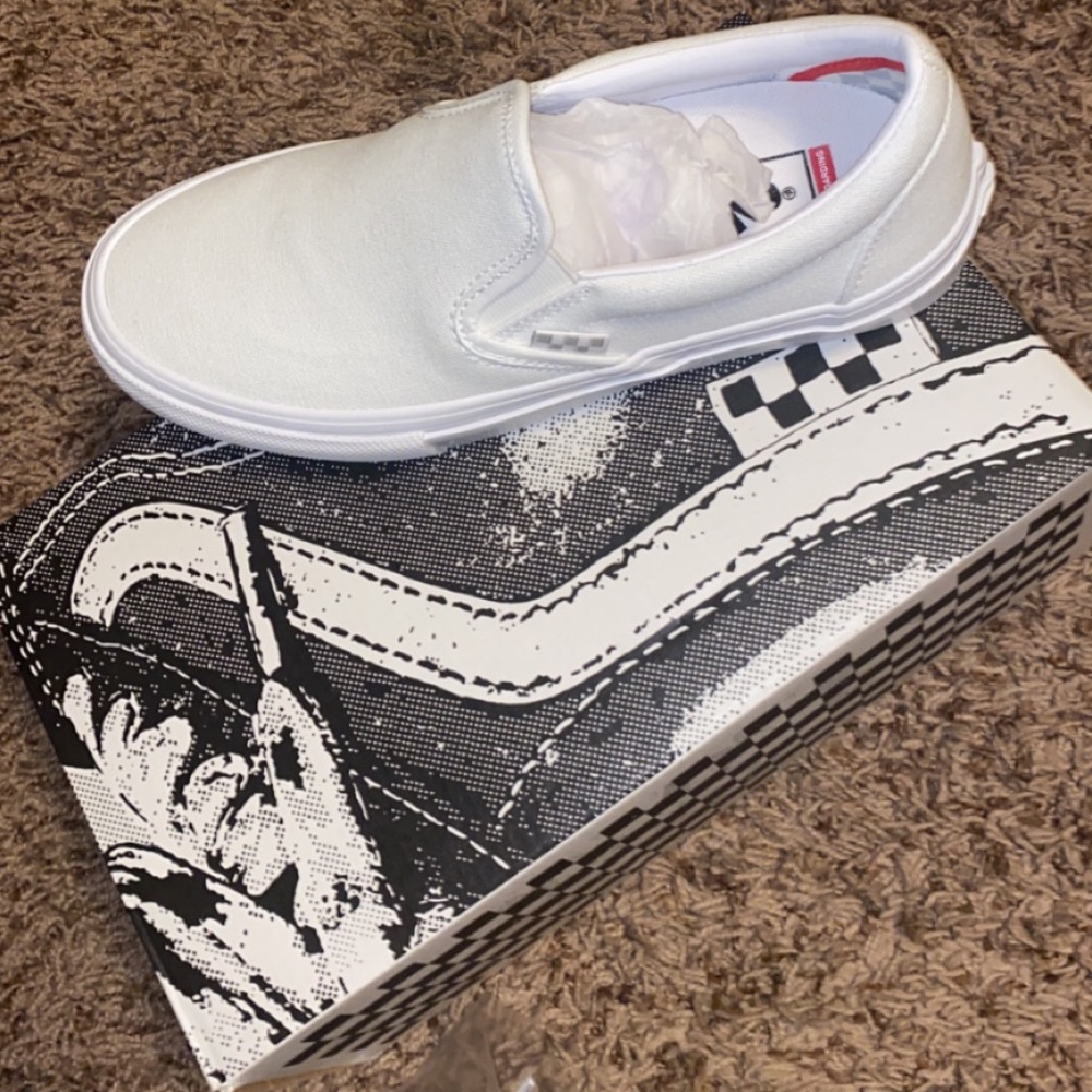 All white slip-on Vans
